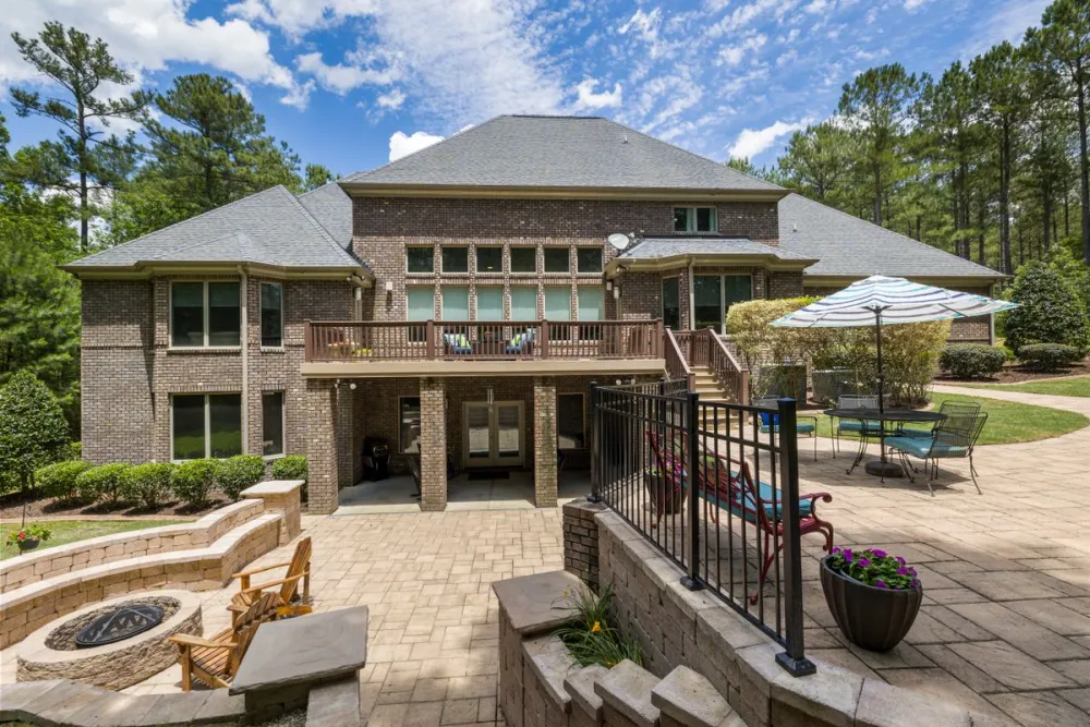 Paver patio and wood deck in a backyard